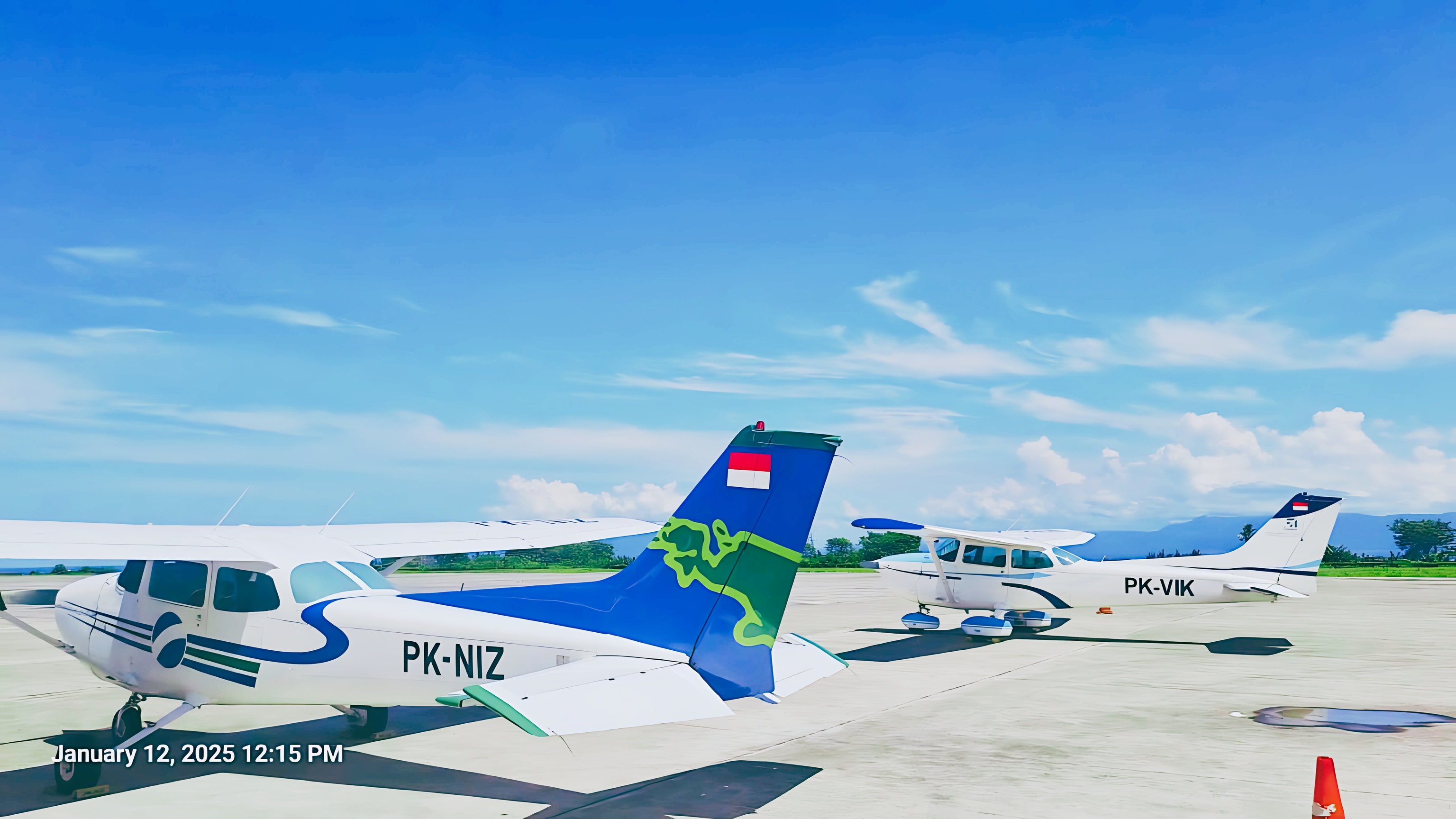 Two Cessna 172 aircraft parked on a sunlit airport apron